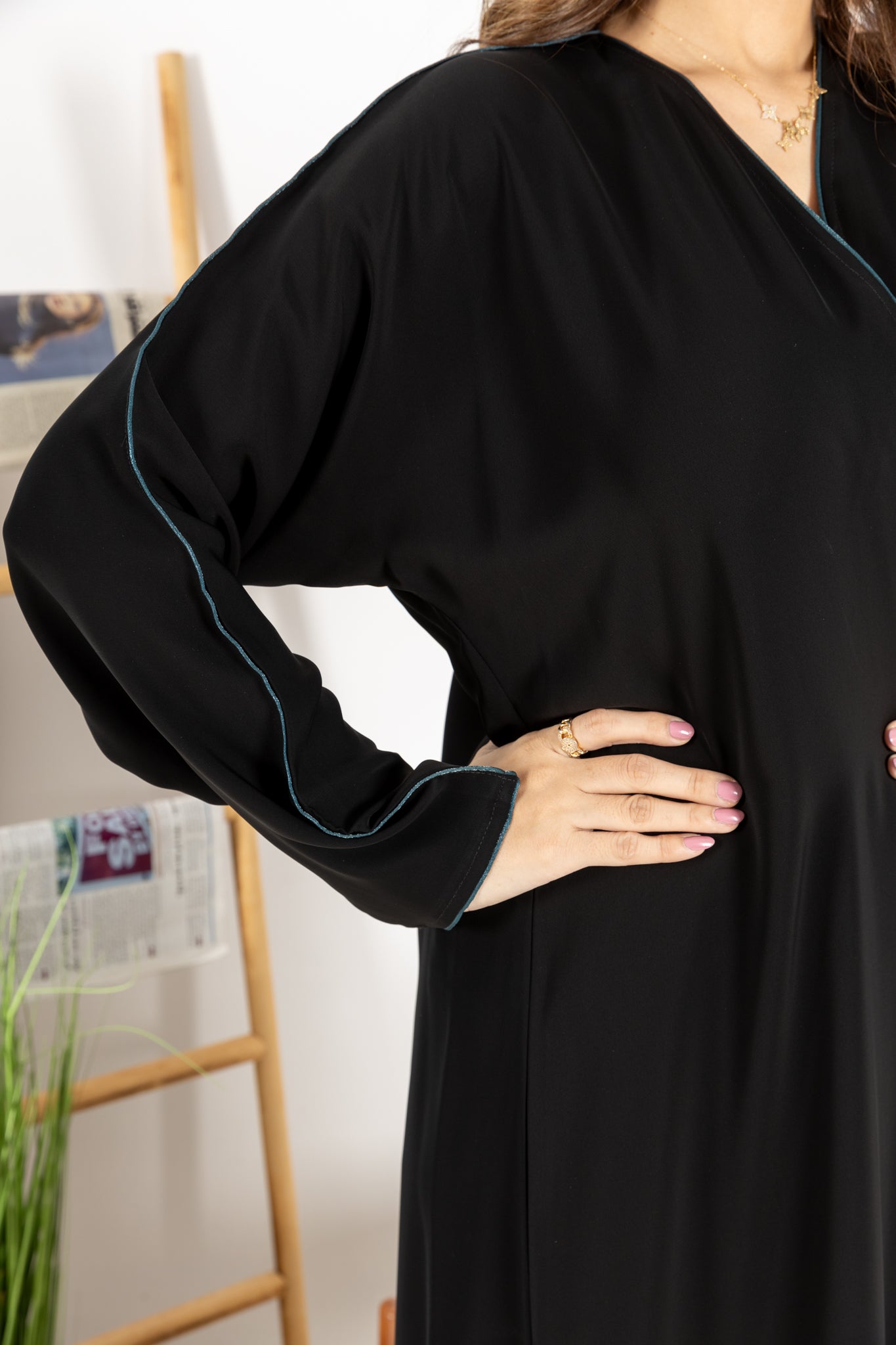 Black abaya trimmed with elegant turquoise lining