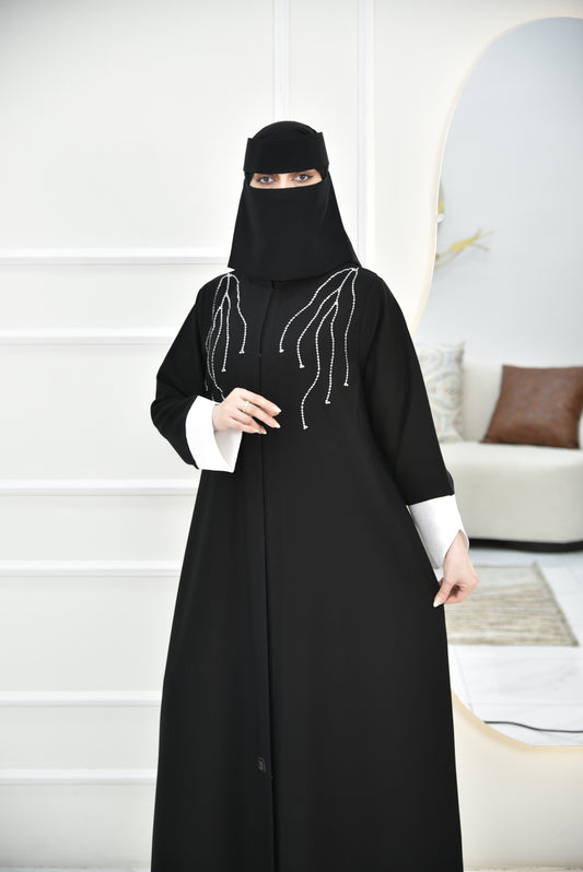 Abaya with white curved sleeves and white embroidery on the shoulders