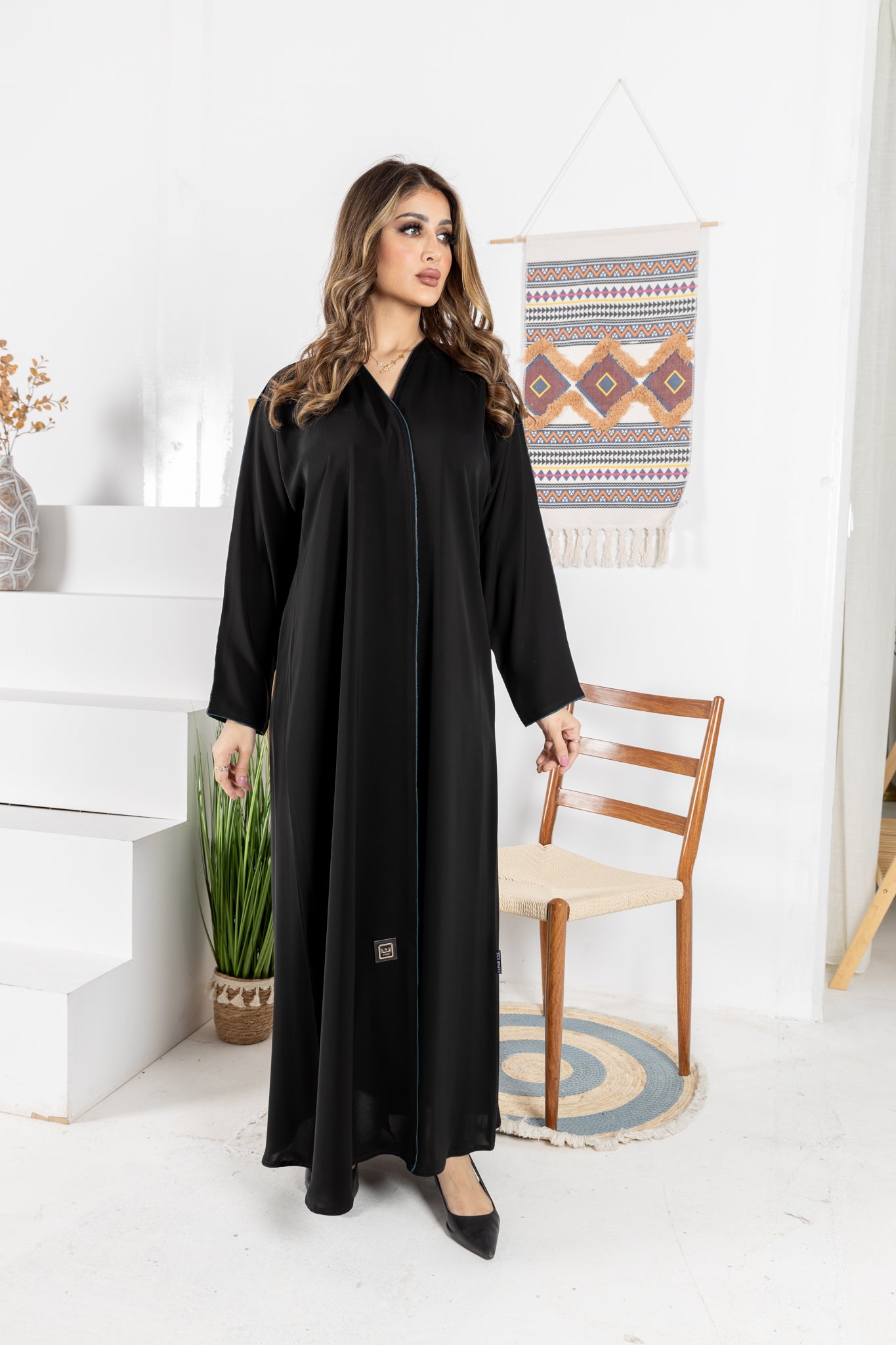 Black abaya trimmed with elegant turquoise lining