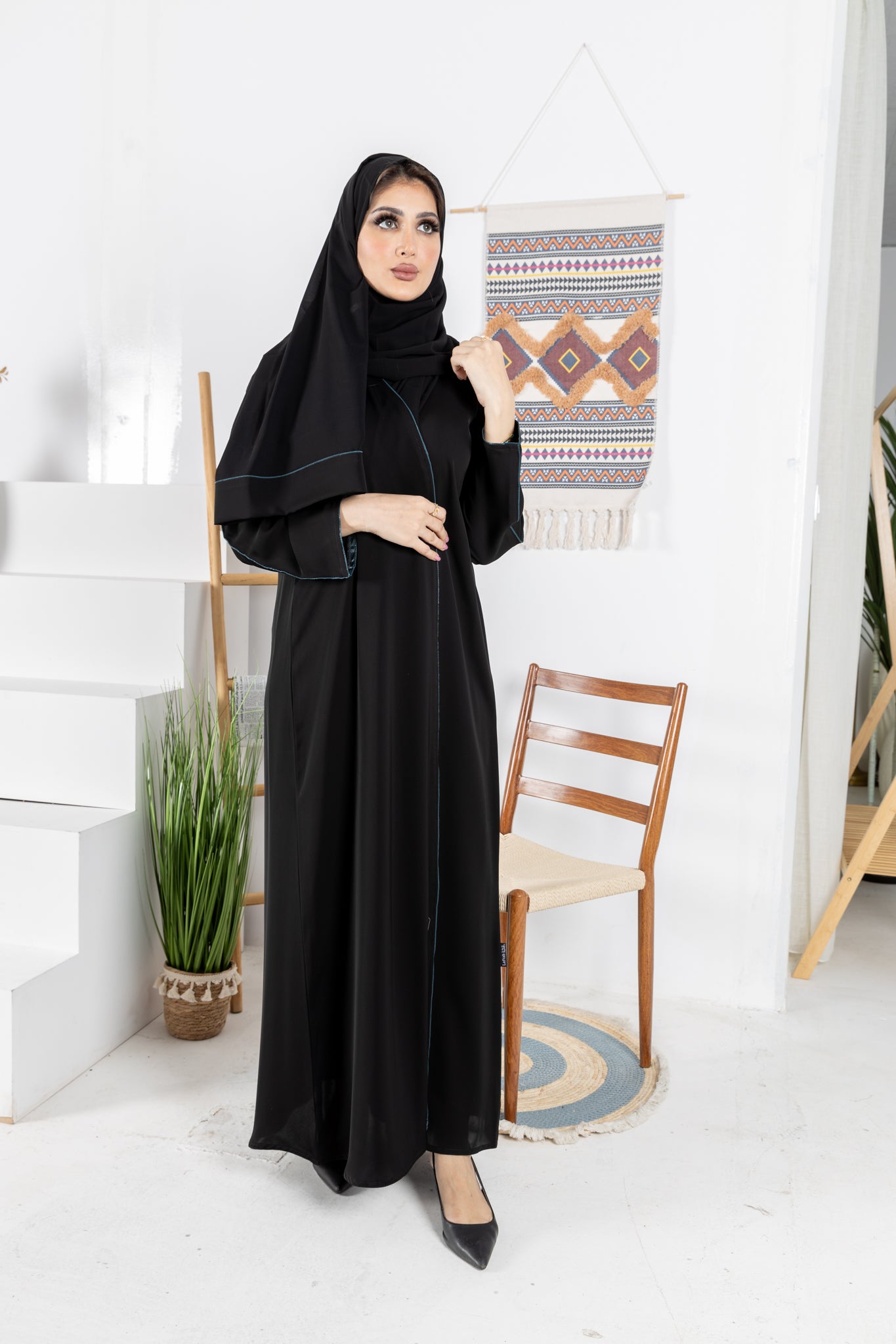 Black abaya trimmed with elegant turquoise lining