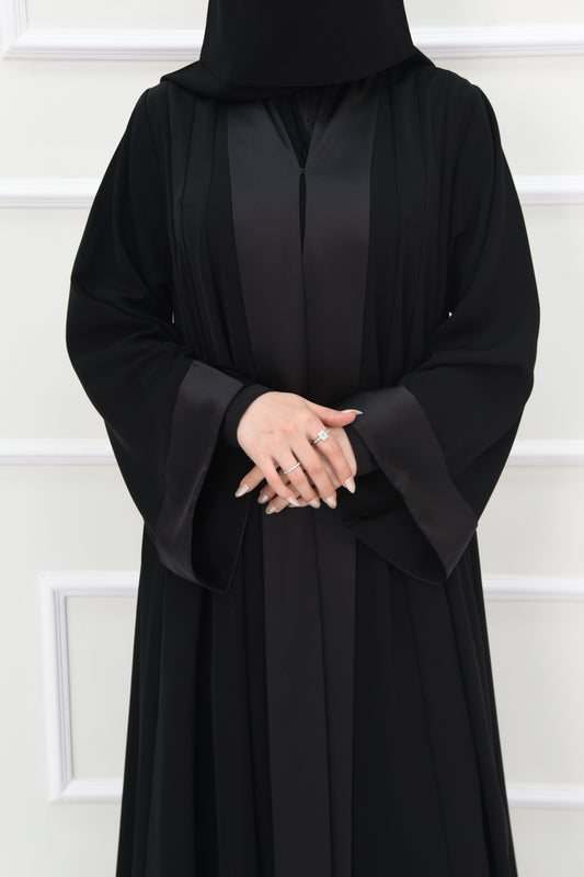 A cloche-style abaya with square sleeves, crafted from satin-blend fabric