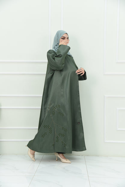 An elegant olive green abaya designed with an exquisite embroidery along the lower hem