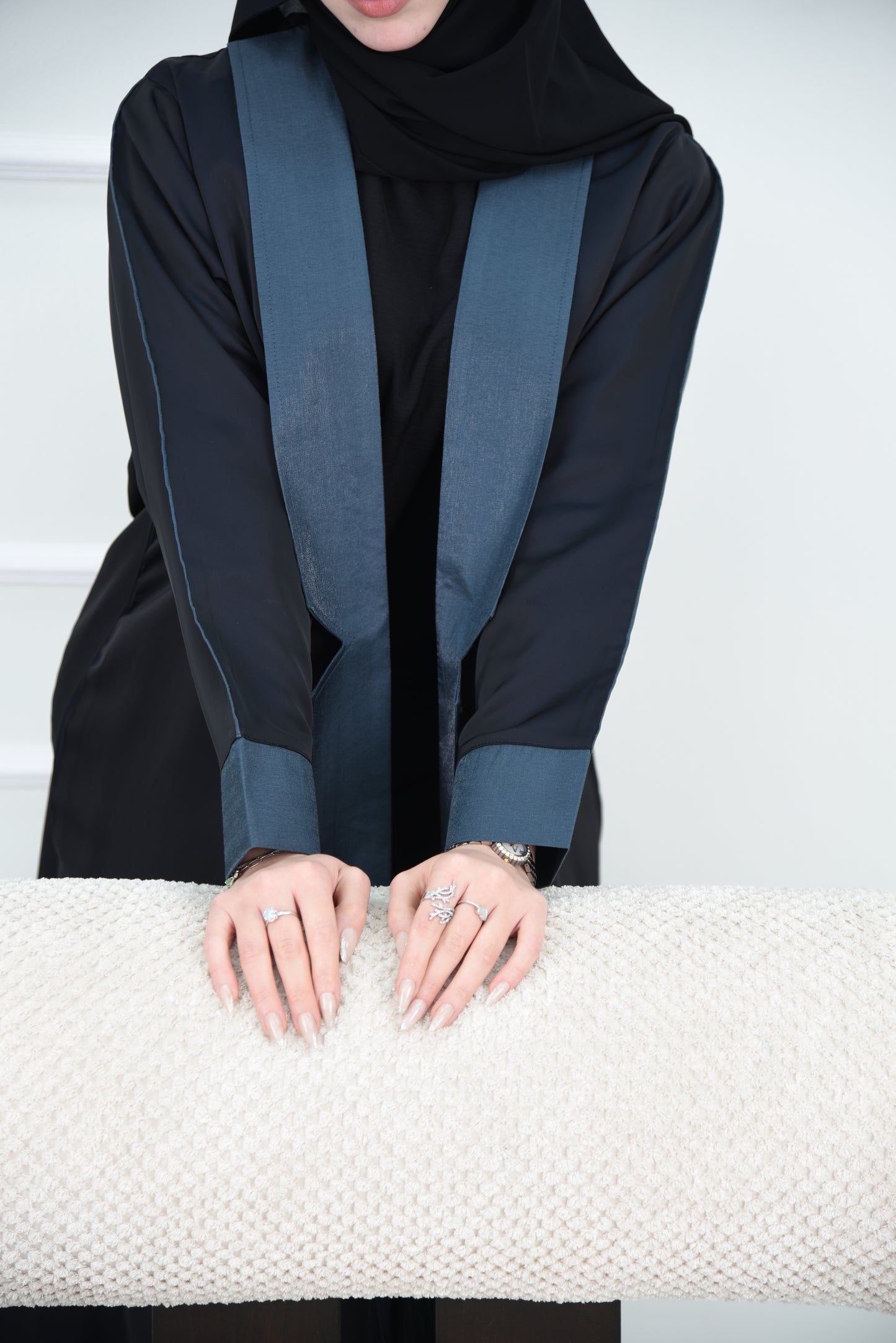 A luxurious satin abaya with blue detailing