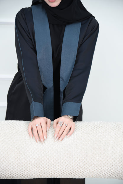 A luxurious satin abaya with blue detailing