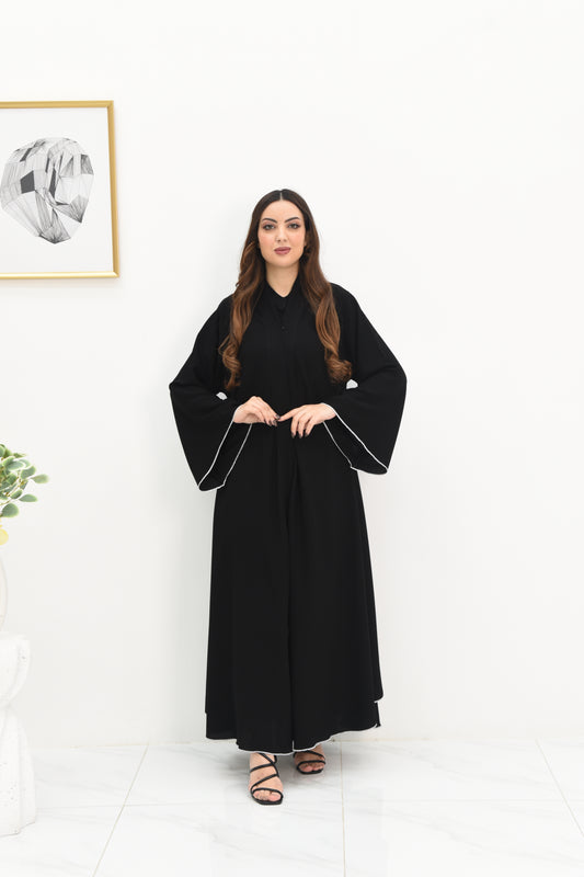 Double flared abaya with white stitched detailing along the edges