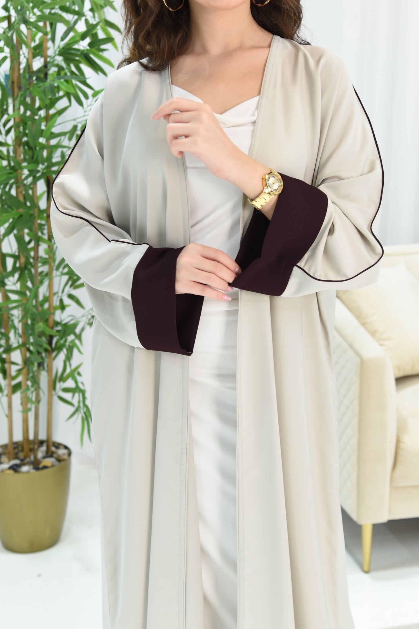 Cream-colored abaya with maroon details