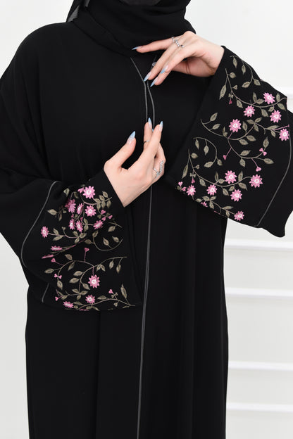 Black abaya adorned with delicate pink embroidery and accented with olive green trim