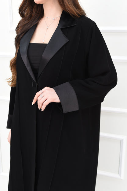 An elegant abaya with a rever collar and satin sleeves