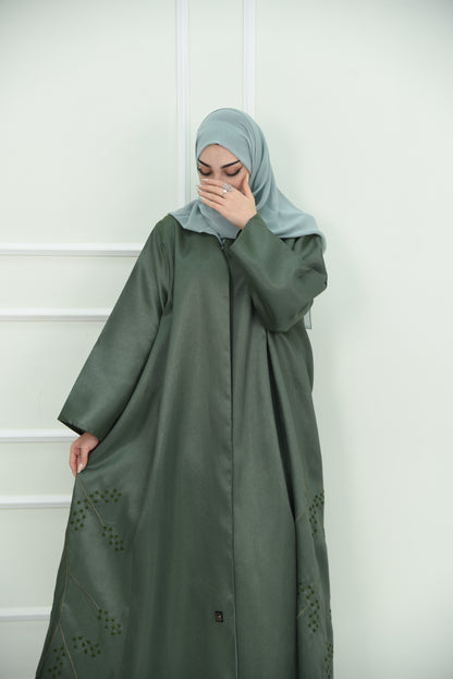 An elegant olive green abaya designed with an exquisite embroidery along the lower hem