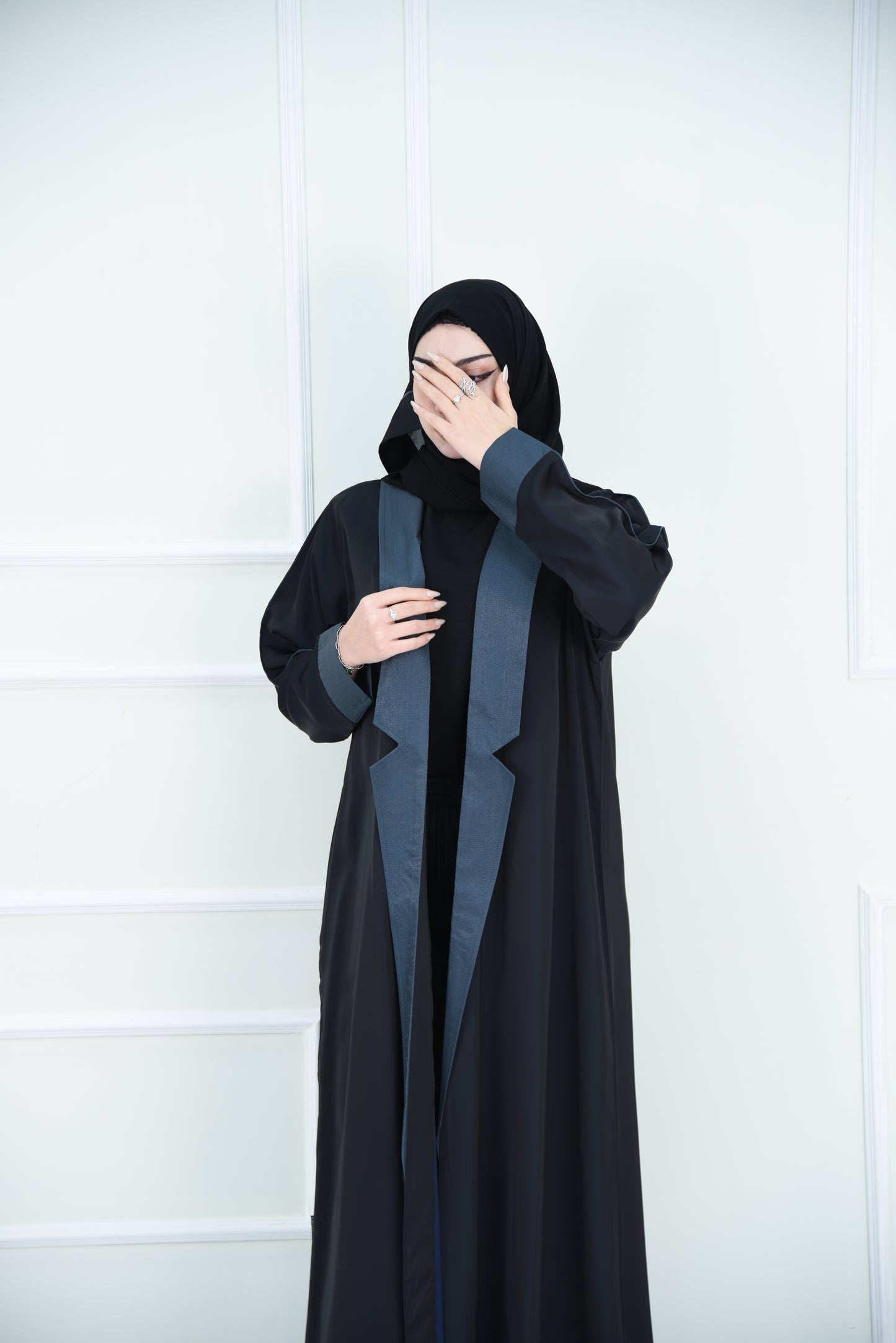 A luxurious satin abaya with blue detailing