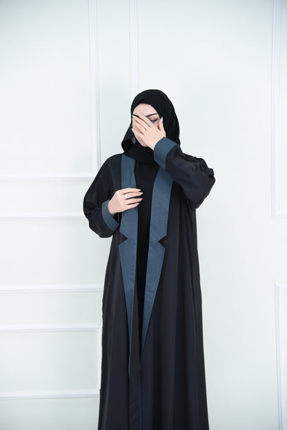 A luxurious satin abaya with blue detailing