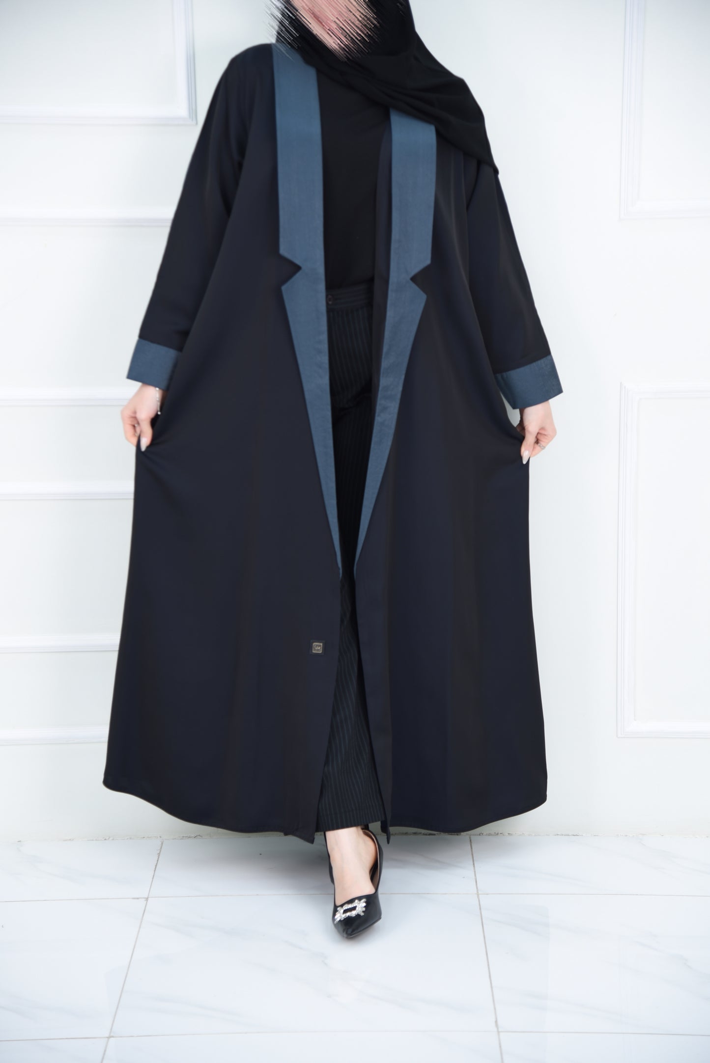 A luxurious satin abaya with blue detailing
