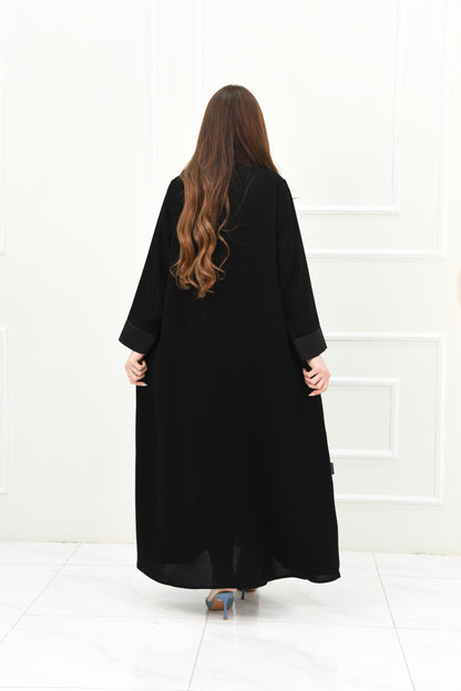 An elegant abaya with a rever collar and satin sleeves