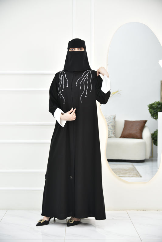 Abaya with white curved sleeves and white embroidery on the shoulders