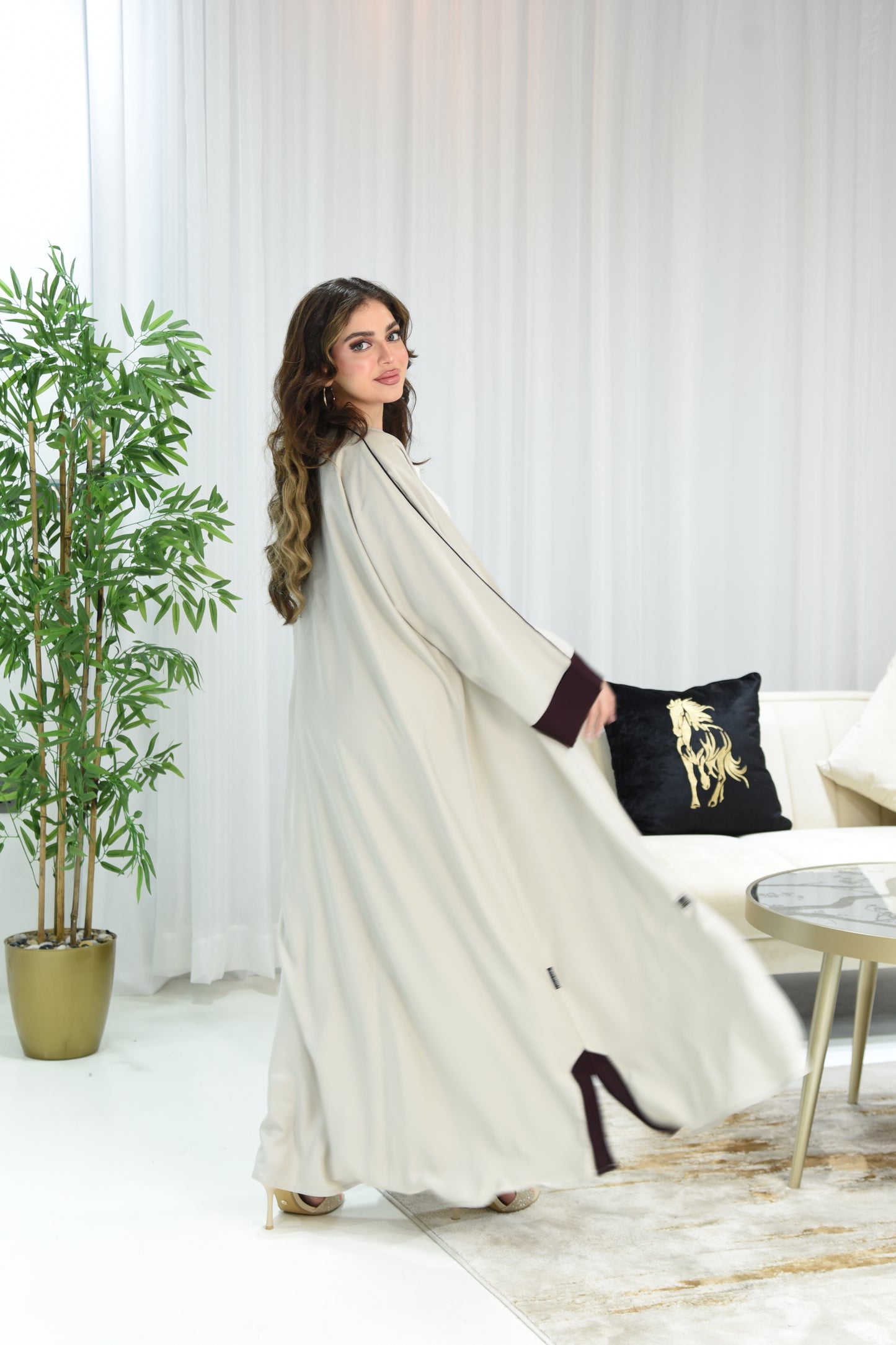 Cream-colored abaya with maroon details