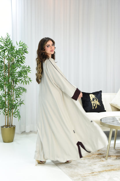 Cream-colored abaya with maroon details