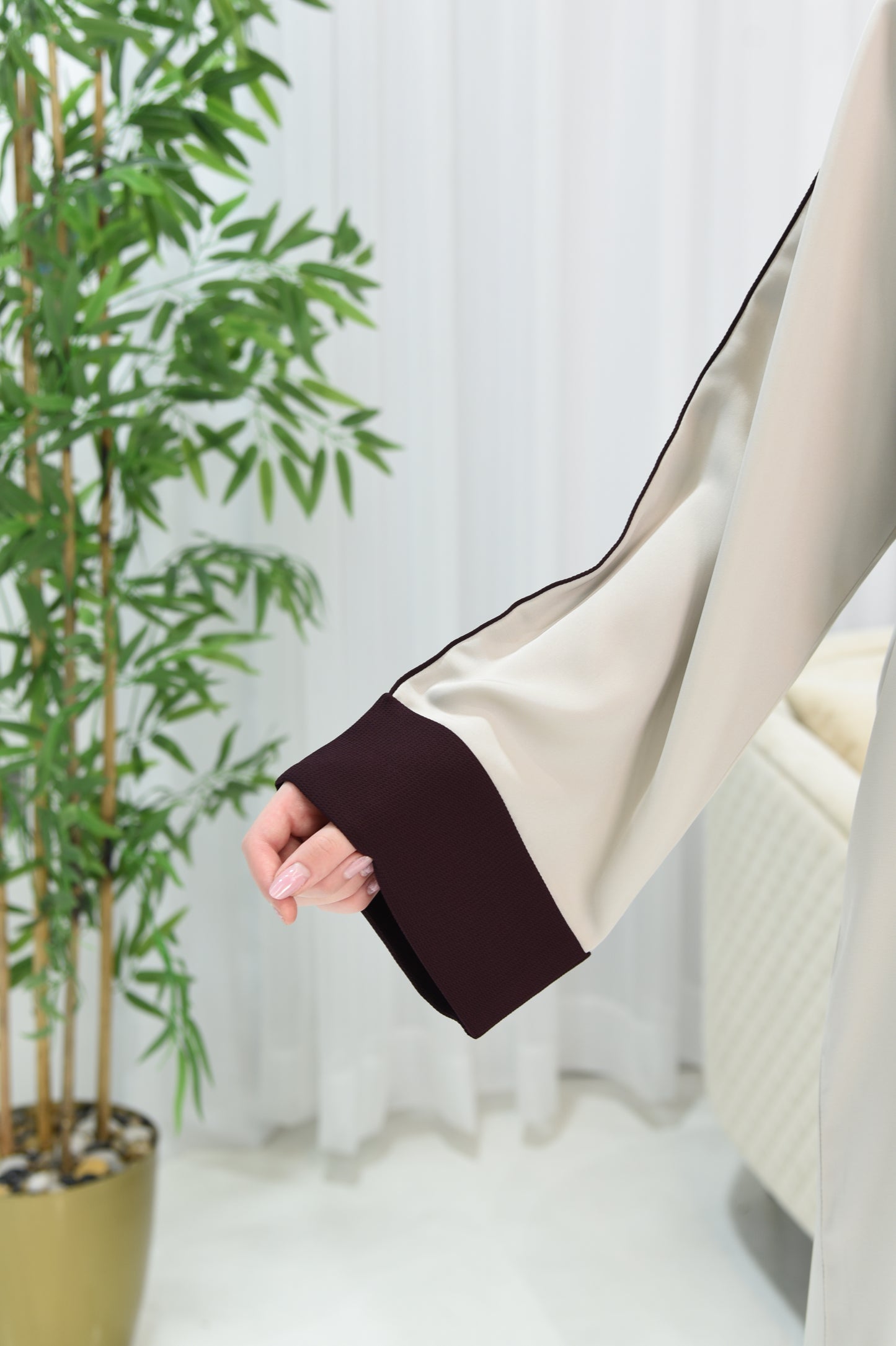 Cream-colored abaya with maroon details